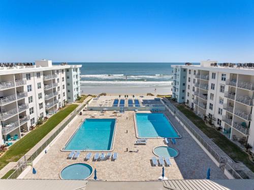 an aerial view of the pool and the beach at Scenic 2br Beachfront Condo Retreat Nsb Fl in New Smyrna Beach