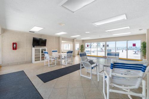 a room with a table and chairs and a television at Scenic 2br Beachfront Condo Retreat Nsb Fl in New Smyrna Beach