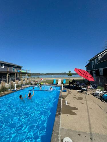 a swimming pool with people in it next to the beach at 1 Queen Bed in Lake City