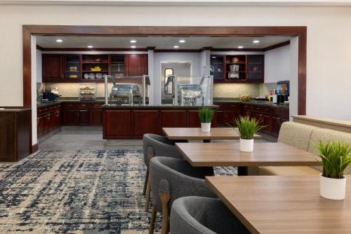 an empty restaurant with tables and a kitchen at Homewood Suites by Hilton Ontario Rancho Cucamonga in Rancho Cucamonga