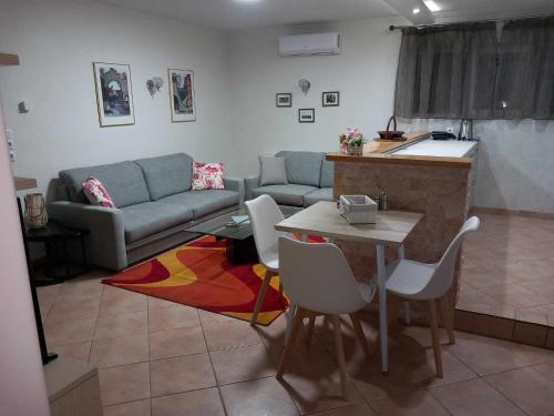 a living room with a couch and a table at GAIA HOUSE-Trikala in Tríkala