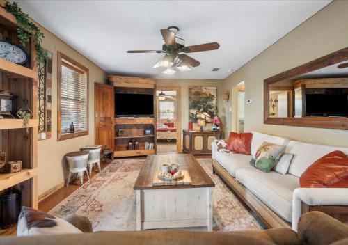 a living room with a couch and a table at Barndominium with Farm and Firepit near Lake Georgetown in Georgetown