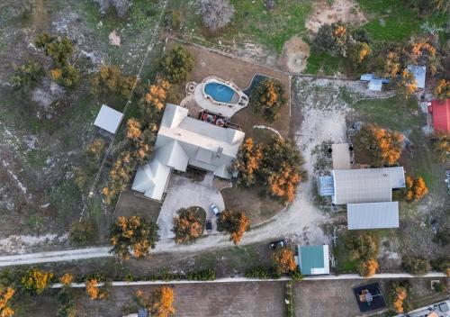 an overhead view of a house with a swimming pool at Barndominium with Farm and Firepit near Lake Georgetown in Georgetown
