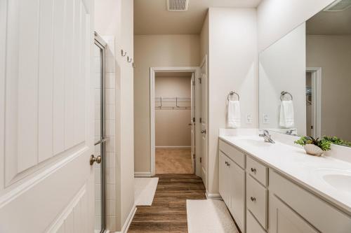 a bathroom with two sinks and a walk in shower at 5 Mi to Bethany Beach Townhome with Pool! in Millville