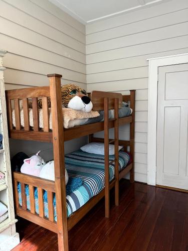 a room with two bunk beds with stuffed animals at Auntys in Kaitaia