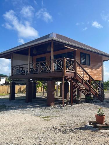 a large log cabin with a porch and a deck at Fareana Lodge Bungalow ho'e in Fakarava
