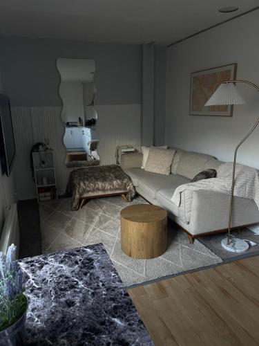 a living room with a couch and a table at Cosy Getaway for 2 in Lindisfarne