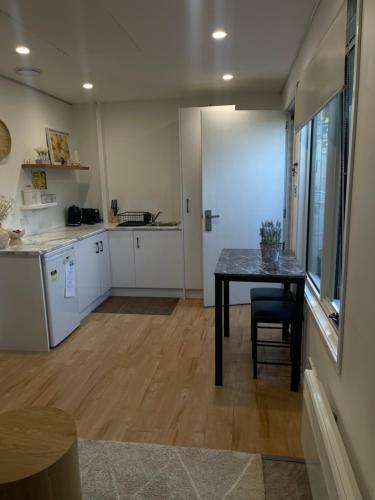 a kitchen with a table and a dining room at Cosy Getaway for 2 in Lindisfarne