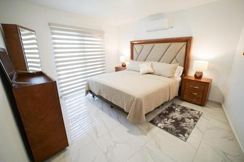 1 dormitorio con 1 cama, vestidor y mesita de noche en Casa Carolina Remodeled Home, en Guadalajara