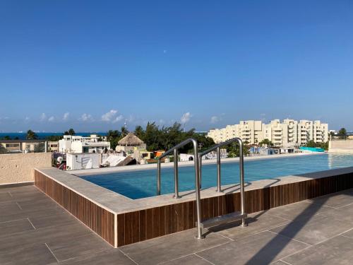 a swimming pool on the roof of a building at La Poza Condominio in Isla Mujeres