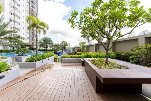 a courtyard with a tree in the middle of a building at Cozy Space by Nomad Space PH at Horizons 101 Cebu City with Pool, Netflix, Wifi in Cebu City