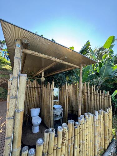 a wooden structure with a toilet and a fence at Glamping Balcón del Cielo in Dosquebradas