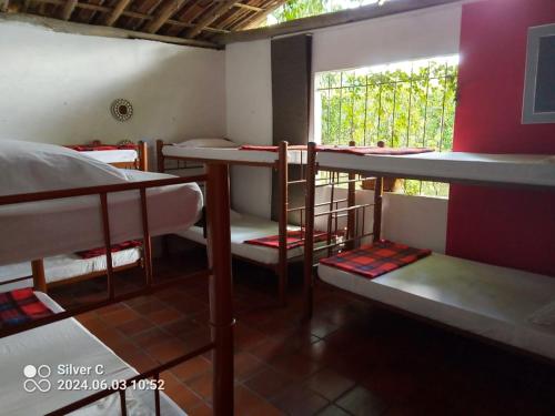 a room with three bunk beds and a window at Finca Santa María Del Lago in Piedecuesta