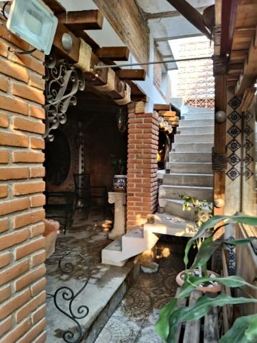 a brick hallway with stairs and a brick wall at Hostal Refugio in Sanctórum