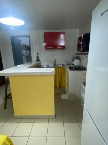 a kitchen with a yellow island in the middle at Bella in Galmot