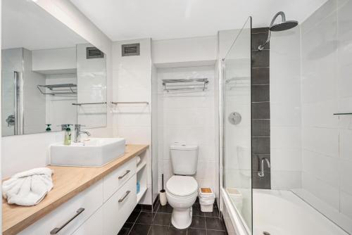 a bathroom with a sink and a toilet and a shower at It's all about the views! in Townsville