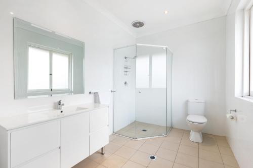 
a bathroom with a sink, toilet and bathtub at Blue Gum Hotel in Hornsby
