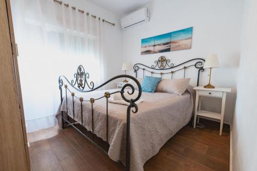 a bedroom with a bed with a metal frame at Cortijo Pinar 2 in Níjar