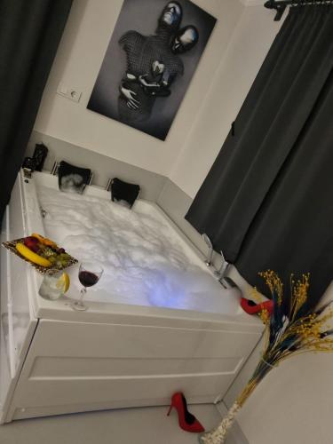 a white bed with a glass of wine on it at Villa Wind in Kaş