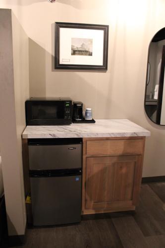 a small kitchen with a microwave and a stove at 4th Street Lofts in Bemidji