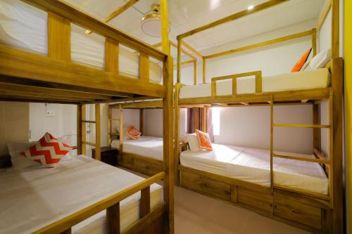 a room with three bunk beds in a hostel at Happy Bear Hostel Phu Quoc in Phu Quoc
