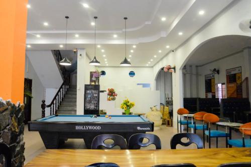 a pool table in the middle of a room at Happy Bear Hostel Phu Quoc in Phu Quoc