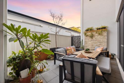 珀斯Stylish Mount Lawley Retreat Walk to Beaufort Street的阳台的天井配有桌椅
