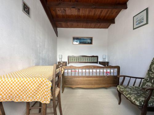 une chambre avec un lit et une chaise dans une pièce dans l'établissement Villa 4 Pièces Proche Plage avec Parking à La Palmyre - FR-1-705-31, aux Mathes