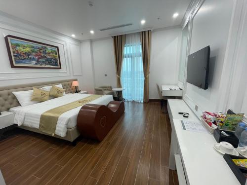 a hotel room with a bed and a flat screen tv at Nguyễn Đức DC Hotel & Spa in Hai Phong