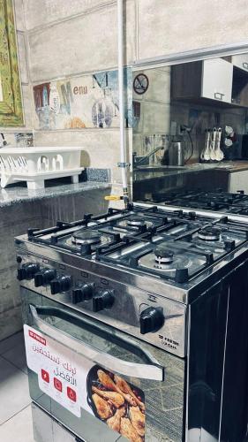 a gas stove in a kitchen with a sign on it at القاهرة in Sheikh Zayed