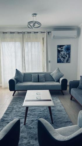 a living room with a couch and a coffee table at القاهرة in Sheikh Zayed