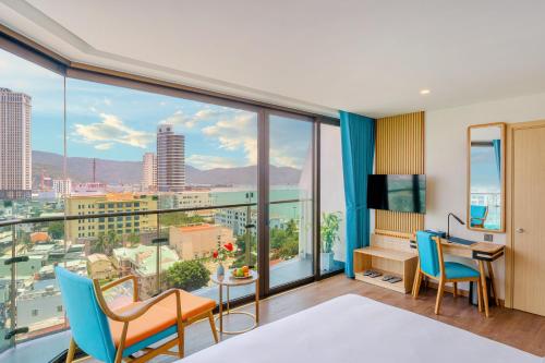 a room with a view of a city at Sala Quy Nhon Beach Hotel in Quy Nhon