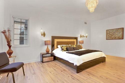 a bedroom with a bed and a chair and a window at Fancy Poconos Castle Indoor MEGA 10plus Hot Tub in East Stroudsburg