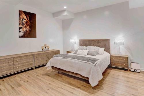 a bedroom with a bed and a painting on the wall at Fancy Poconos Castle Indoor MEGA 10plus Hot Tub in East Stroudsburg