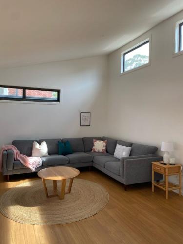 a living room with a couch and a table at Large Cowes Getaway- Fireplace, Near the Beach in Cowes