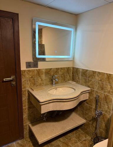 a bathroom with a sink and a mirror at The Guest House Hunza in Karimabad Hunza