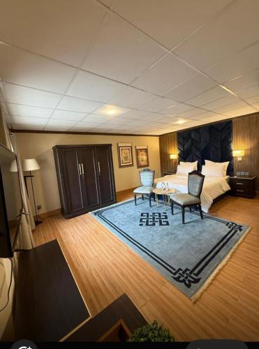 a hotel room with a bed and a table and chairs at The Guest House Hunza in Karimabad Hunza