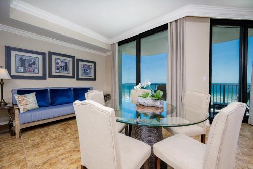 un salon avec une table en verre et des chaises dans l'établissement Phoenix IX 506 condo, à Orange Beach