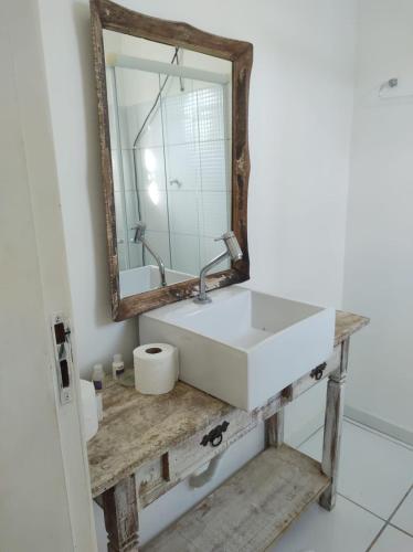 a bathroom with a white sink and a mirror at Villa Di Antonio in Tiradentes
