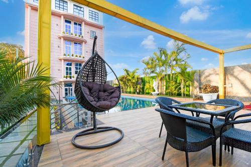 a patio with a hammock and chairs and a pool at Hotel O M H Club And Resorts in Rānchī