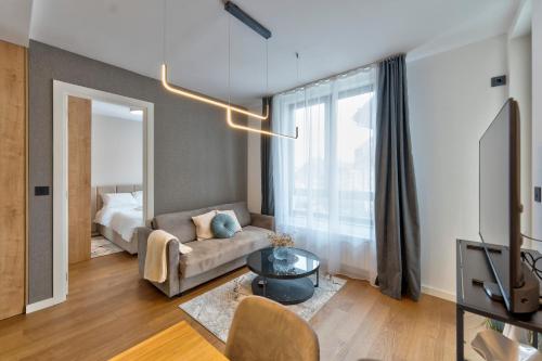 a living room with a couch and a bed at Luxury Zlatibor Aria in Zlatibor
