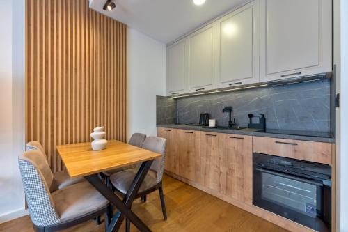 a kitchen with a wooden table and a wooden counter at Luxury Zlatibor Aria in Zlatibor
