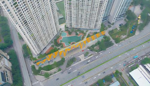 an overhead view of a highway in a city with tall buildings at HN ETH Vinhomes D'capitale Resident - Tran Duy Hung St in Hanoi