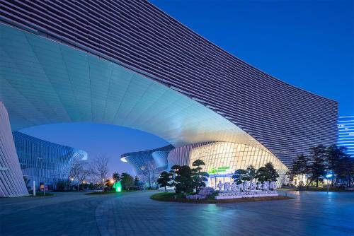 a view of a building with a blue sky at Holiday Inn Express Yangzhou Grand Canal Theatre in Yangzhou
