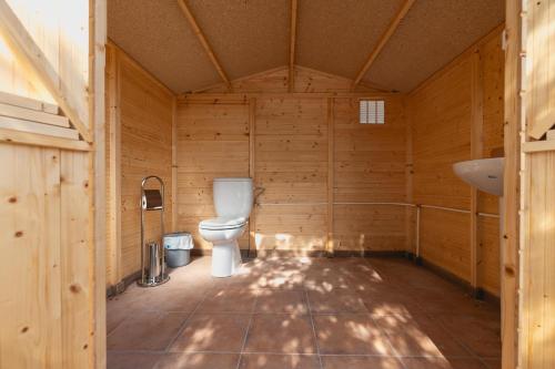 a bathroom with a toilet in a wooden room at Cortijo El Pinar 1 in Níjar