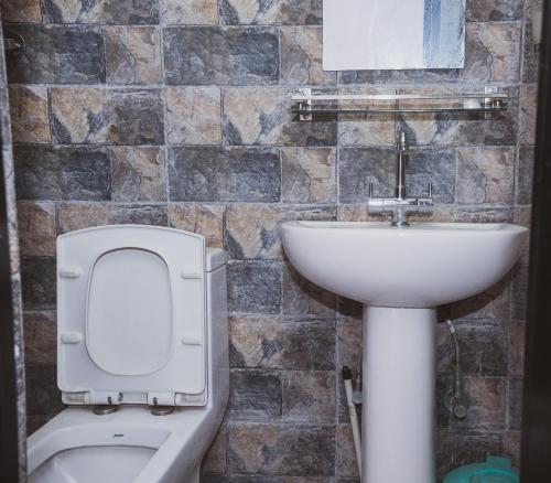 a bathroom with a toilet and a sink at k2Homes in Pātan