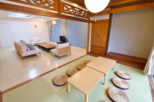 a living room with a table and chairs and a couch at Itomann IN in Sunja