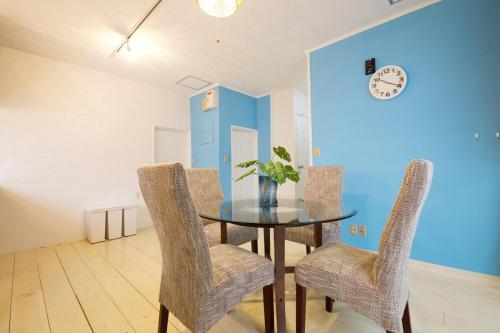 a dining room with a glass table and two chairs at Itomann IN in Sunja