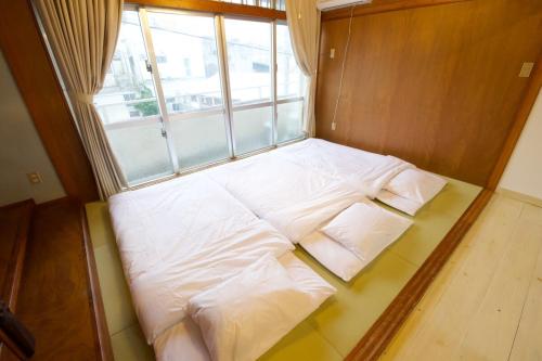 a large bed in a room with a window at Itomann IN in Sunja