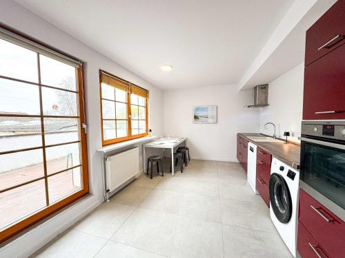 a kitchen with a sink and a table in it at Large Apartment for Large Groups south of Berlin in Großbeeren